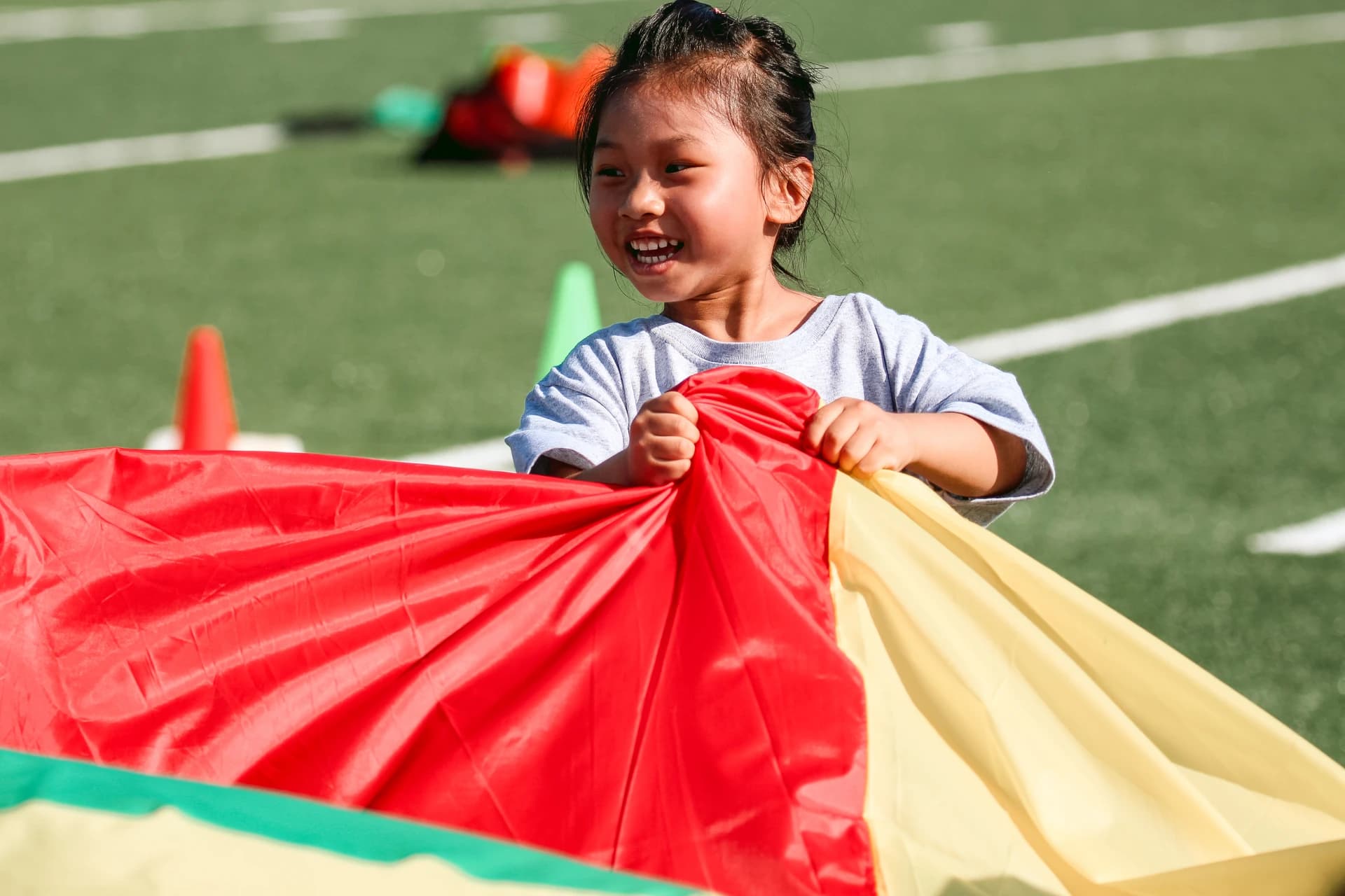 Child holding a colorful parachute