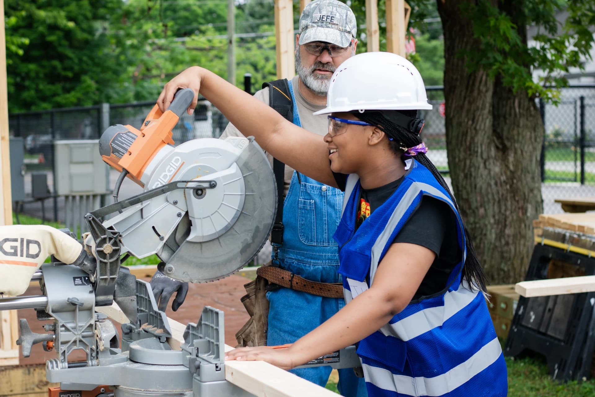 Student using a saw with an instructor