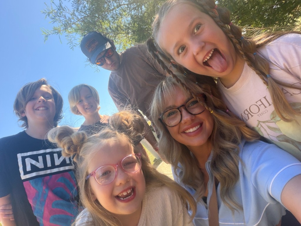 Olivia Backus outdoors with her husband and their four children