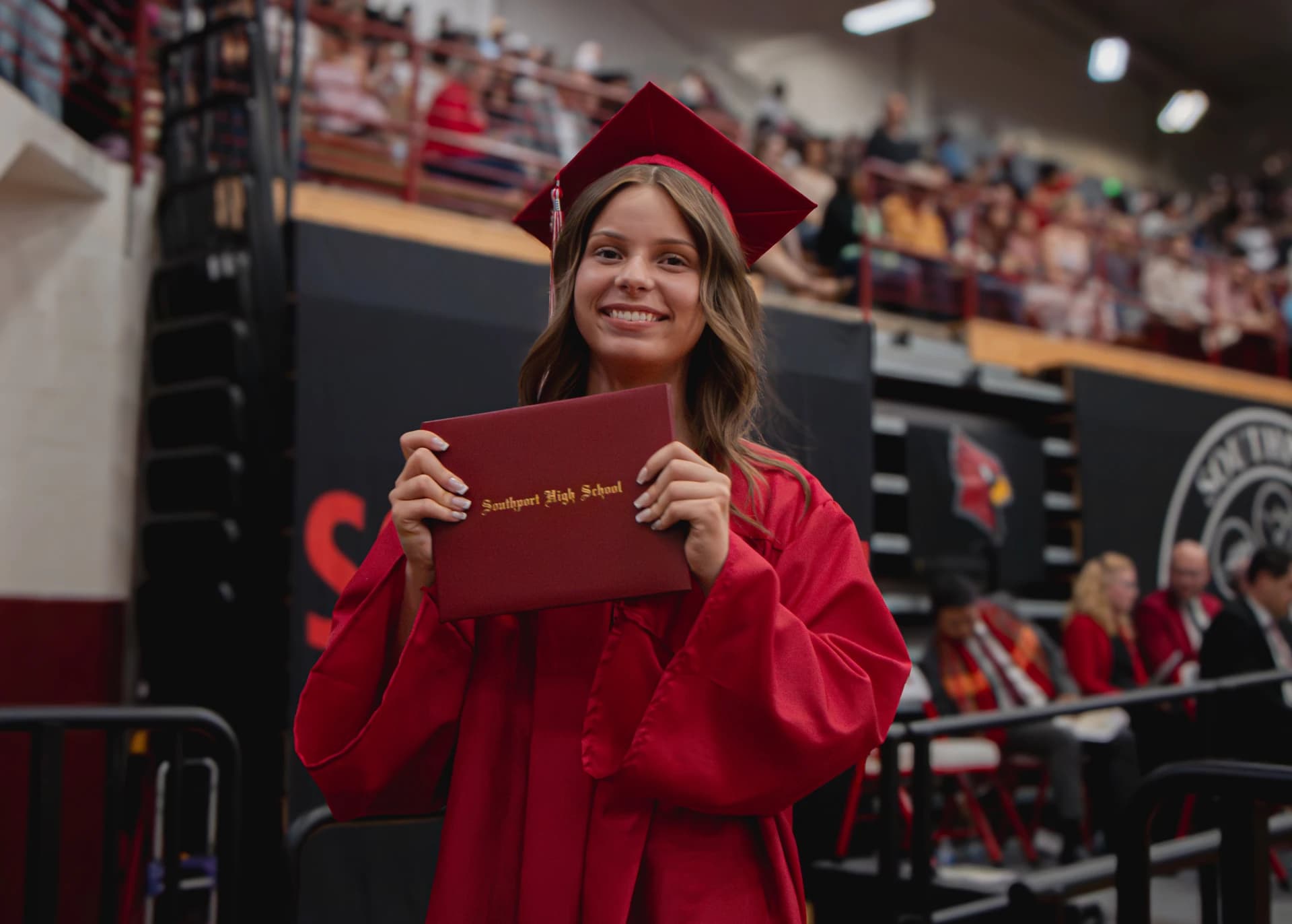 Graduate holding a diploma